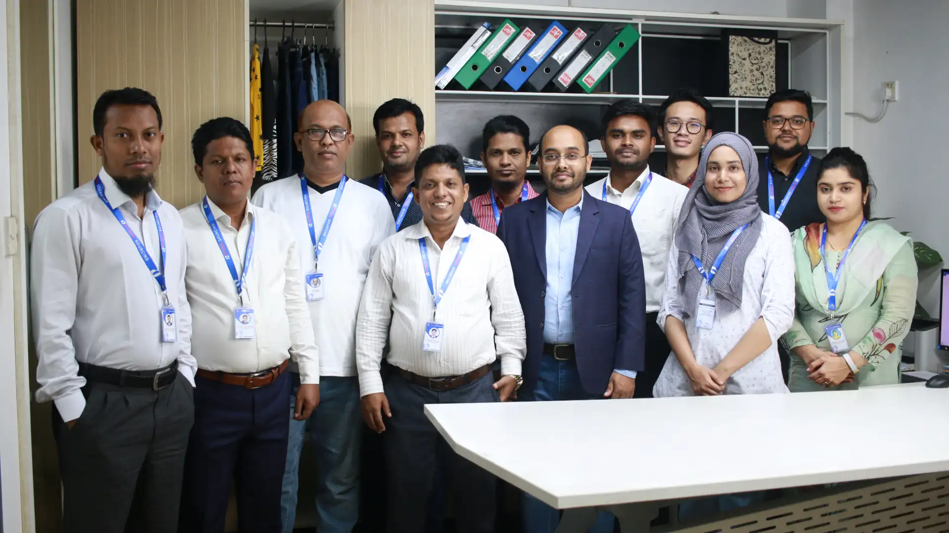 Team members of RYZEAL SOURCING, a clothing manufacturer and apparel sourcing company in Bangladesh, gathered for a professional group photo at the office.